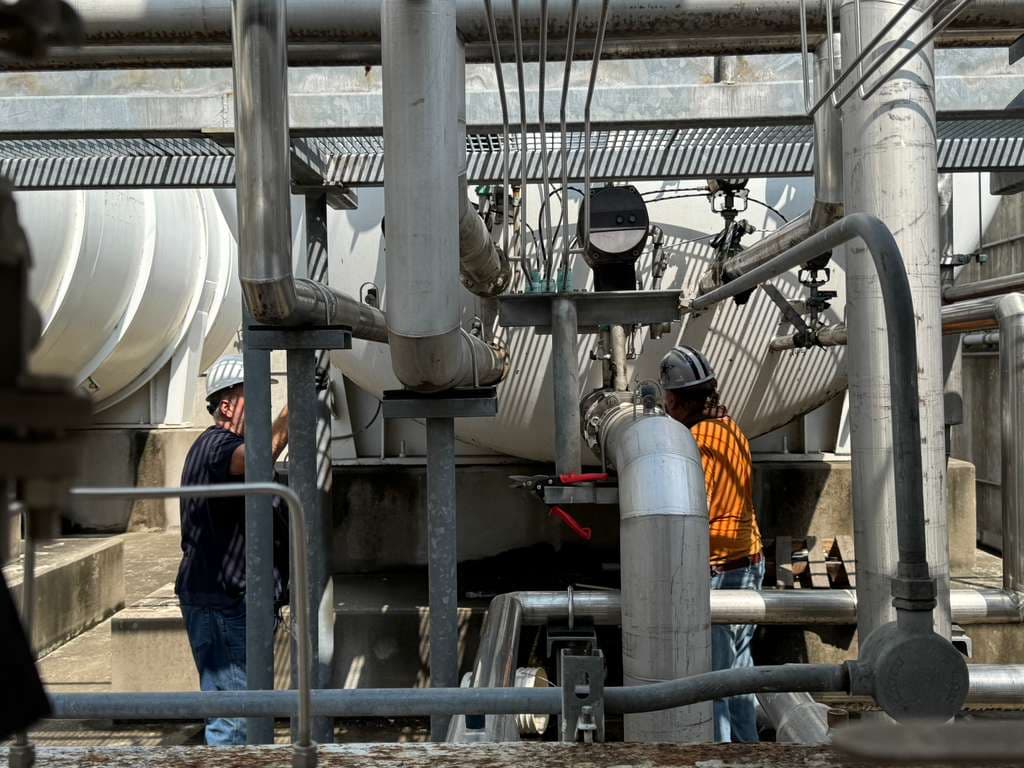 Certified crew dismantling industrial cryogenic piping system on-site